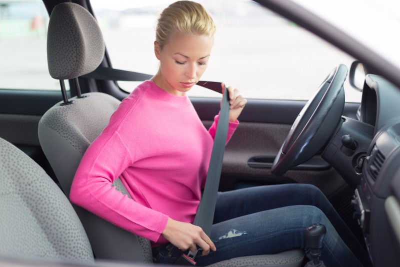 lady fastening her car seat belt